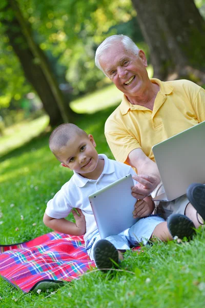 Grandfather and child using laptop — Stock Photo, Image