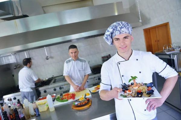 Group of handsome chefs dressed in white uniform — Stock Photo, Image