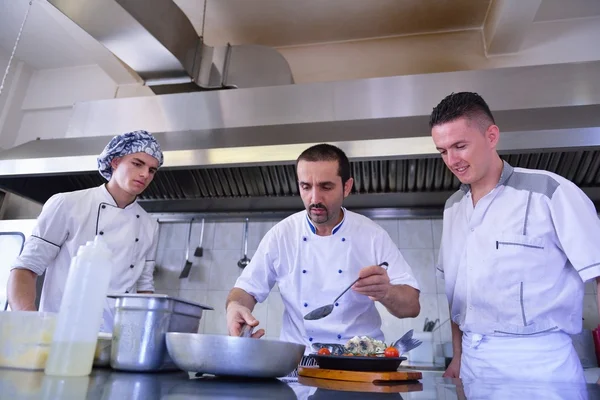 Group of handsome chefs dressed in white uniform — Stock Photo, Image