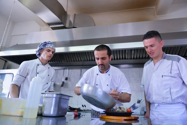 Group of handsome chefs dressed in white uniform — Stock Photo, Image