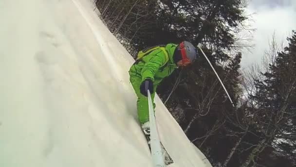 Skier går ned ad bakke med kamera på hans hjelm og i hånden – Stock-video