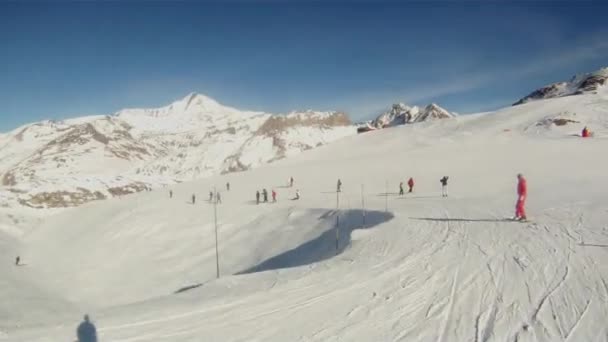 Лыжник гонится за сноубордистом с камерой на шлеме — стоковое видео