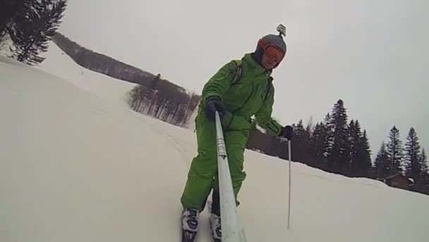 Ski sport, man going downhill with camera — Stock Video