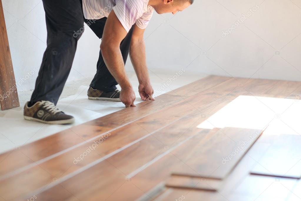Man Installing laminate flooring