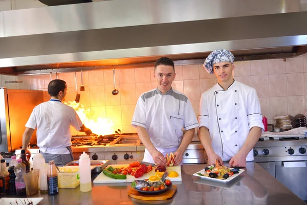 Group of handsome chefs dressed in white uniform — Stock Photo, Image