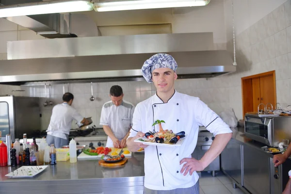 Group of handsome chefs dressed in white uniform — Stock Photo, Image