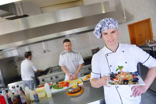 Group of handsome chefs dressed in white uniform — Stock Photo, Image