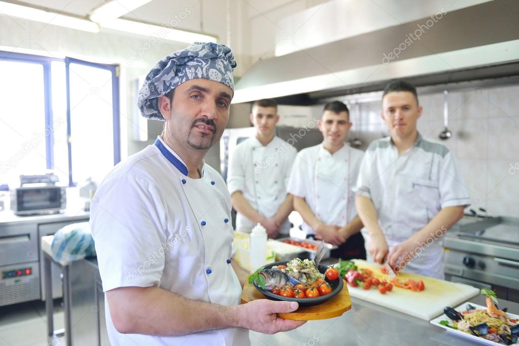 Group of handsome chefs dressed in white uniform