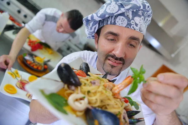 Chef decorating pasta salad — Stock Photo, Image