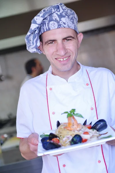 Chef with seafood pasta salad — Stock Photo, Image