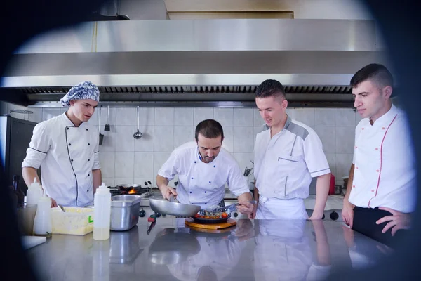 Group of handsome chefs dressed in white uniform — Stock Photo, Image