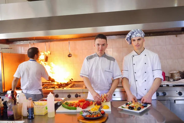 Group of handsome chefs dressed in white uniform — Stock Photo, Image