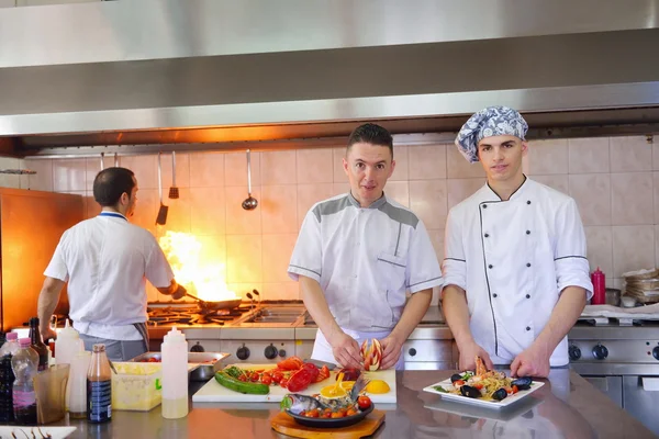 Group of handsome chefs dressed in white uniform — Stock Photo, Image