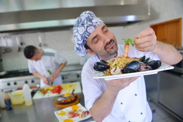 Chef decorating pasta salad — Stock Photo, Image