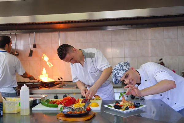 Group of handsome chefs dressed in white uniform — Stock Photo, Image