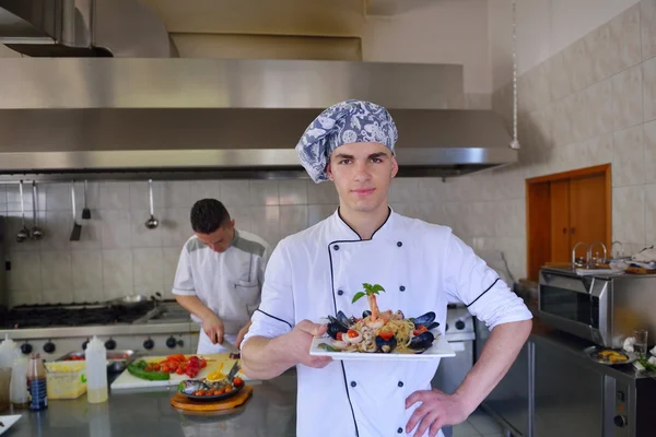 Chef decorating seafood pasta salad — Stock Photo, Image