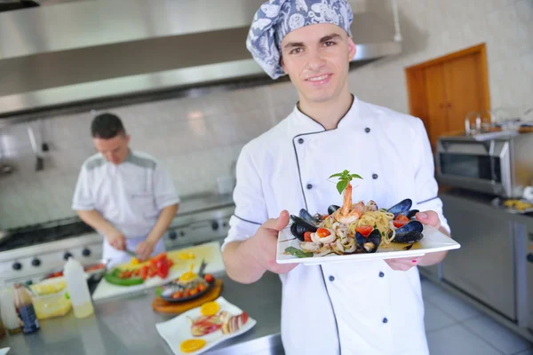 Chef decorating seafood pasta salad — Stock Photo, Image