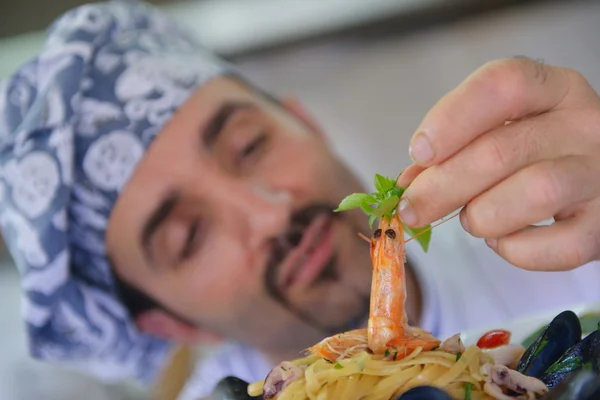 Chef decorating pasta salad — Stock Photo, Image