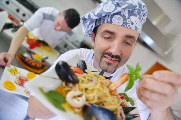 Chef decorating pasta salad — Stock Photo, Image