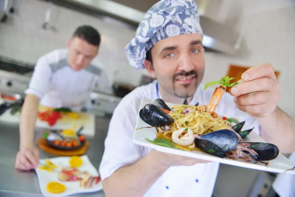 Chef decorating pasta salad — Stock Photo, Image