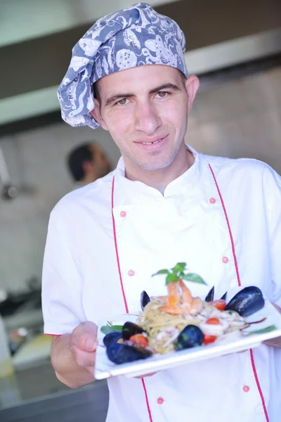 Chef with seafood pasta salad — Stock Photo, Image