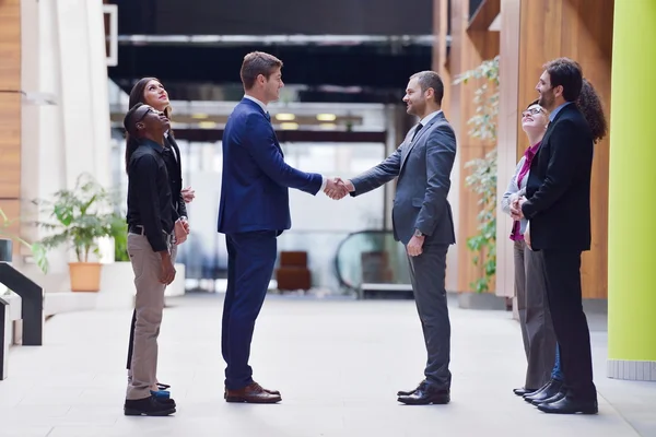 Young business people shaking hands — Stock Photo, Image