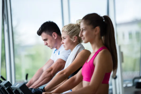 Amigos haciendo ejercicio en una cinta de correr en el gimnasio — Foto de Stock