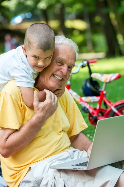 Grandfather and child using laptop computer — Stock Photo, Image