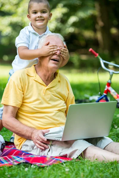 Grandfather and child using laptop computer — Stock Photo, Image