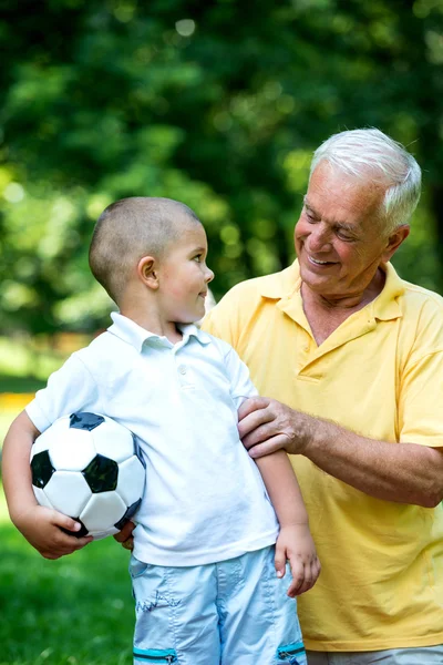 Grandfather and child have fun in park — Stock Photo, Image