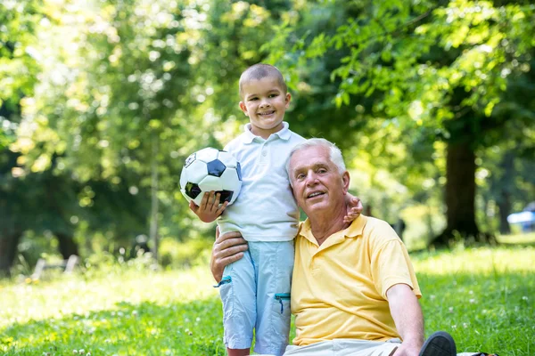 Grandfather and child have fun in park