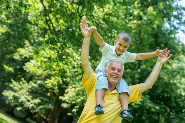 Grandfather and child have fun in park — Stock Photo, Image