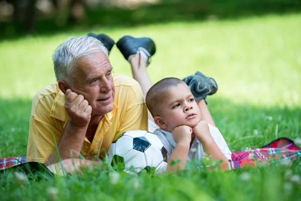 Grandfather and child have fun in park — Stock Photo, Image