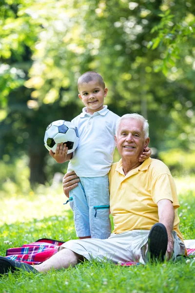 Grandfather and child have fun in park — Stock Photo, Image