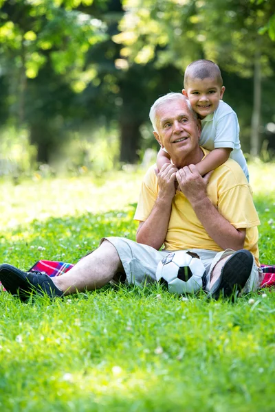 Grandfather and child have fun in park — Stock Photo, Image