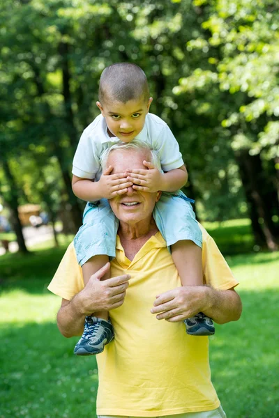 Grandfather and child have fun in park — Stock Photo, Image