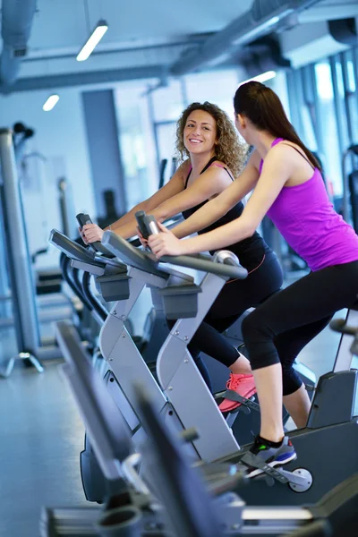 Two Women  on exercise bikes — Stock Photo, Image