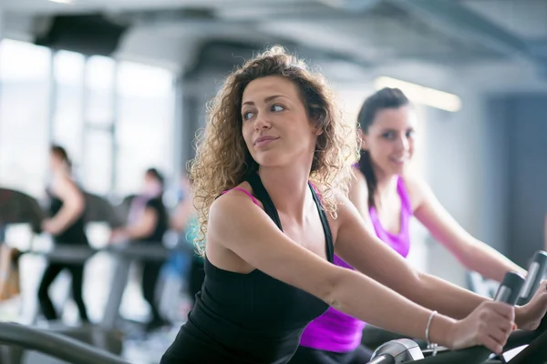 Two Women  on exercise bikes — Stock Photo, Image