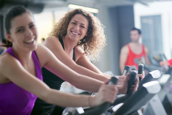 Two Women  on exercise bikes — Stock Photo, Image