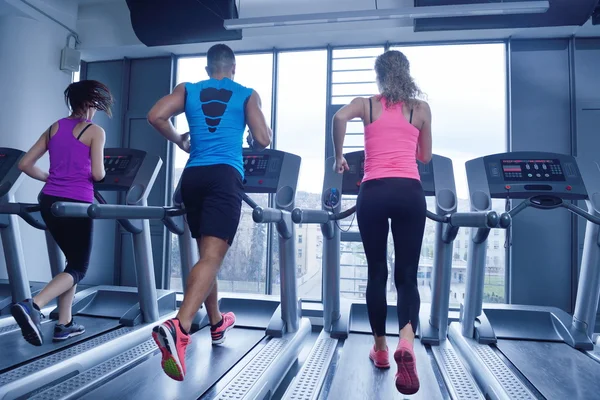 Vrouw oefenen op loopband in sportschool — Stockfoto