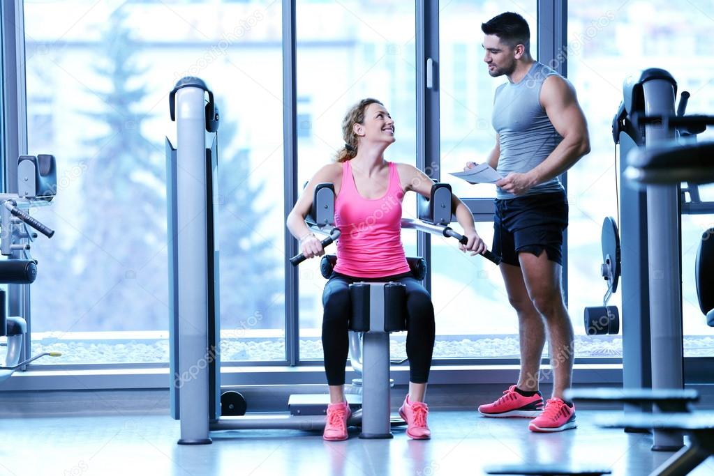 Woman exercising with her personal trainer