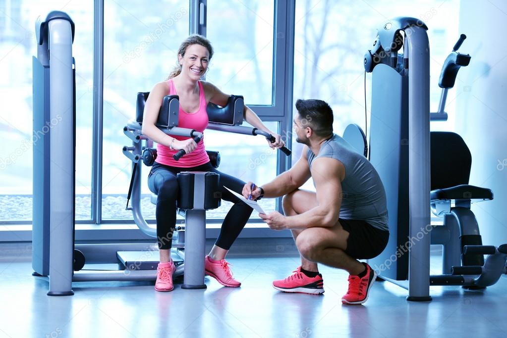 Woman exercising with her personal trainer