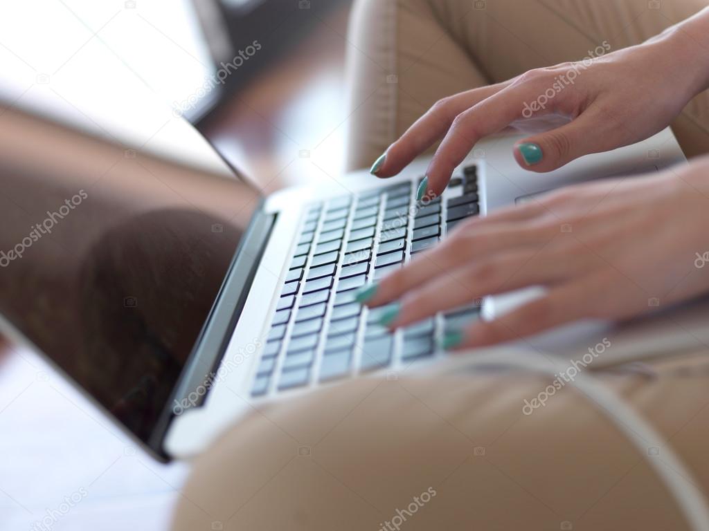 Woman at home working on laptop computer