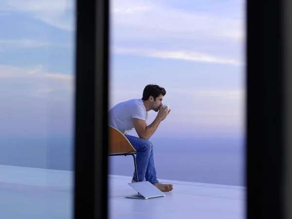 Relaxed young man at home balcony — Stock Photo, Image