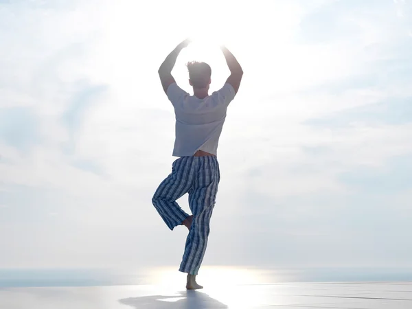 Young man practicing yoga — Stock Photo, Image