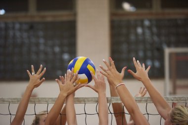young beautiful girls playing Volleyball clipart