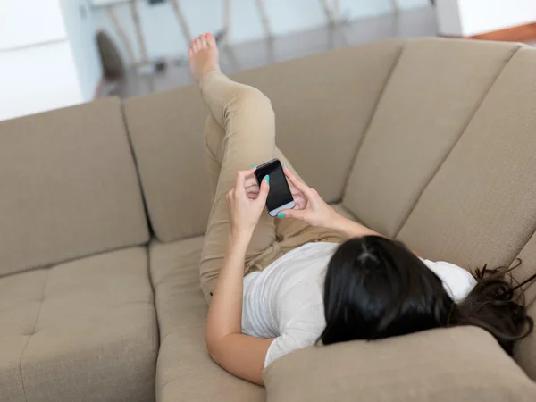 Frau auf Couch mit Handy — Stockfoto