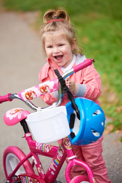 Little girl with bicycle Stock Image