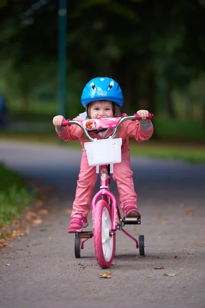 Little girl with bicycle — Stock Photo, Image