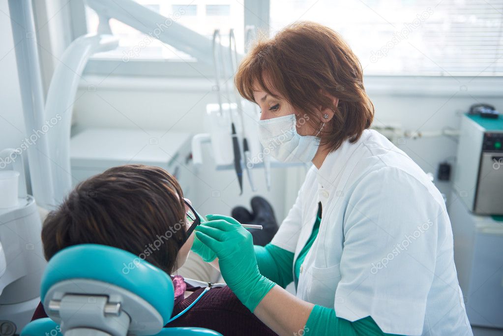 Closeup of a woman patient at the dentist being checked up